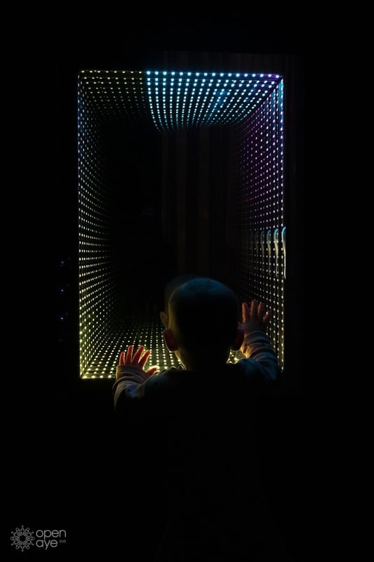 Open Aye. a child looks at a light installation.